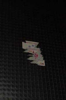 Close-up of a custom vinyl sticker being peeled off its backing