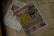 A newspaper is placed on a tiled floor. The headline in large yellow letters stands out. Next to it, there is an advertisement showing electronic massage devices. The overall setting seems casual and informal.