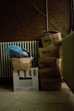 a pile of boxes sitting next to a radiator