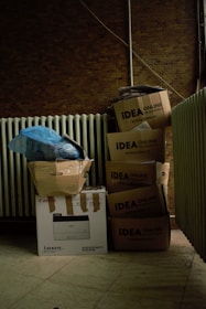 a pile of boxes sitting next to a radiator