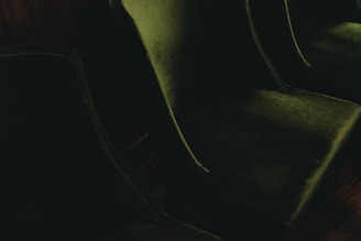 a couple of green chairs sitting on top of a wooden floor