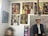 A gallery wall featuring multiple paintings. The artworks include various portraits and abstract pieces, showcasing people in traditional attire and colorful abstract patterns. The floor has a stack of boxes with objects on top.