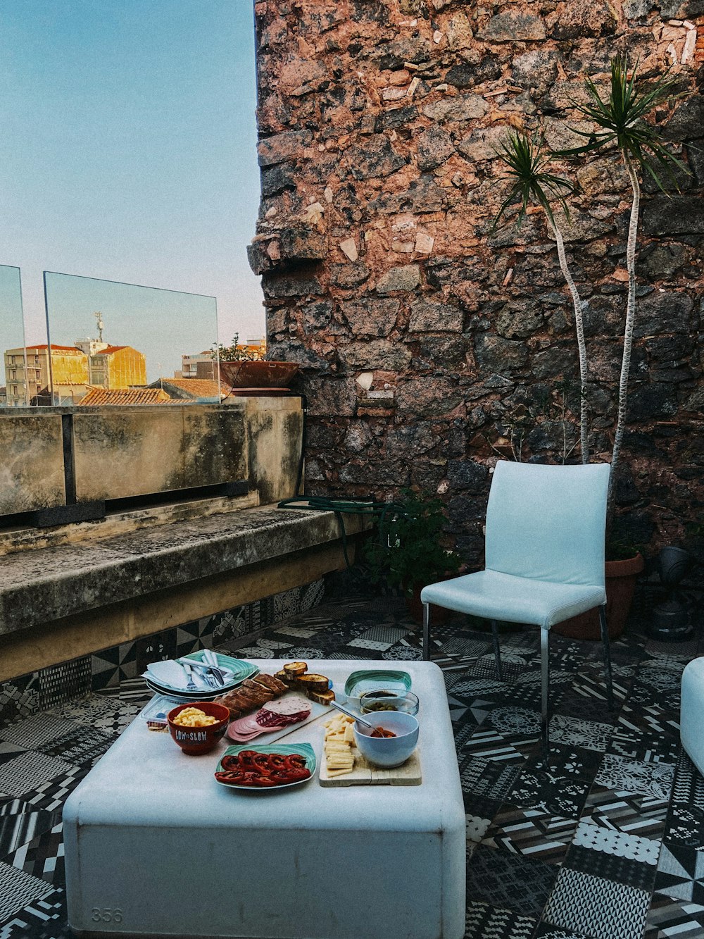 a table with food on top of it next to a white chair