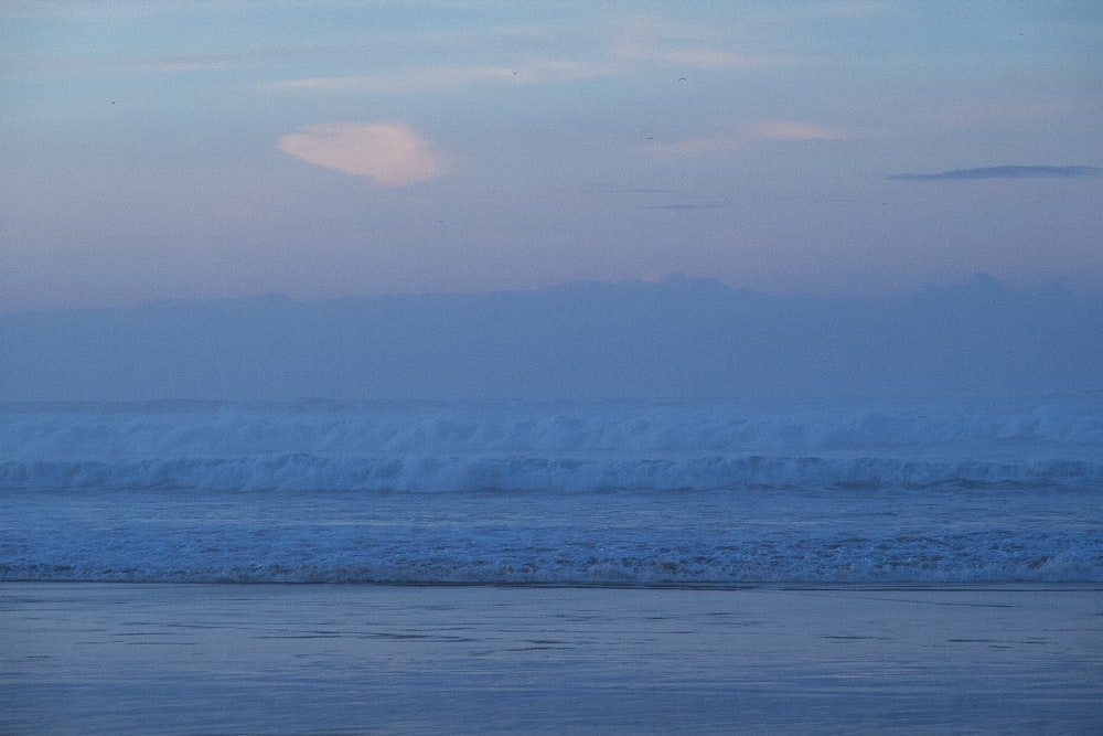 a person riding a surfboard on a wave in the ocean