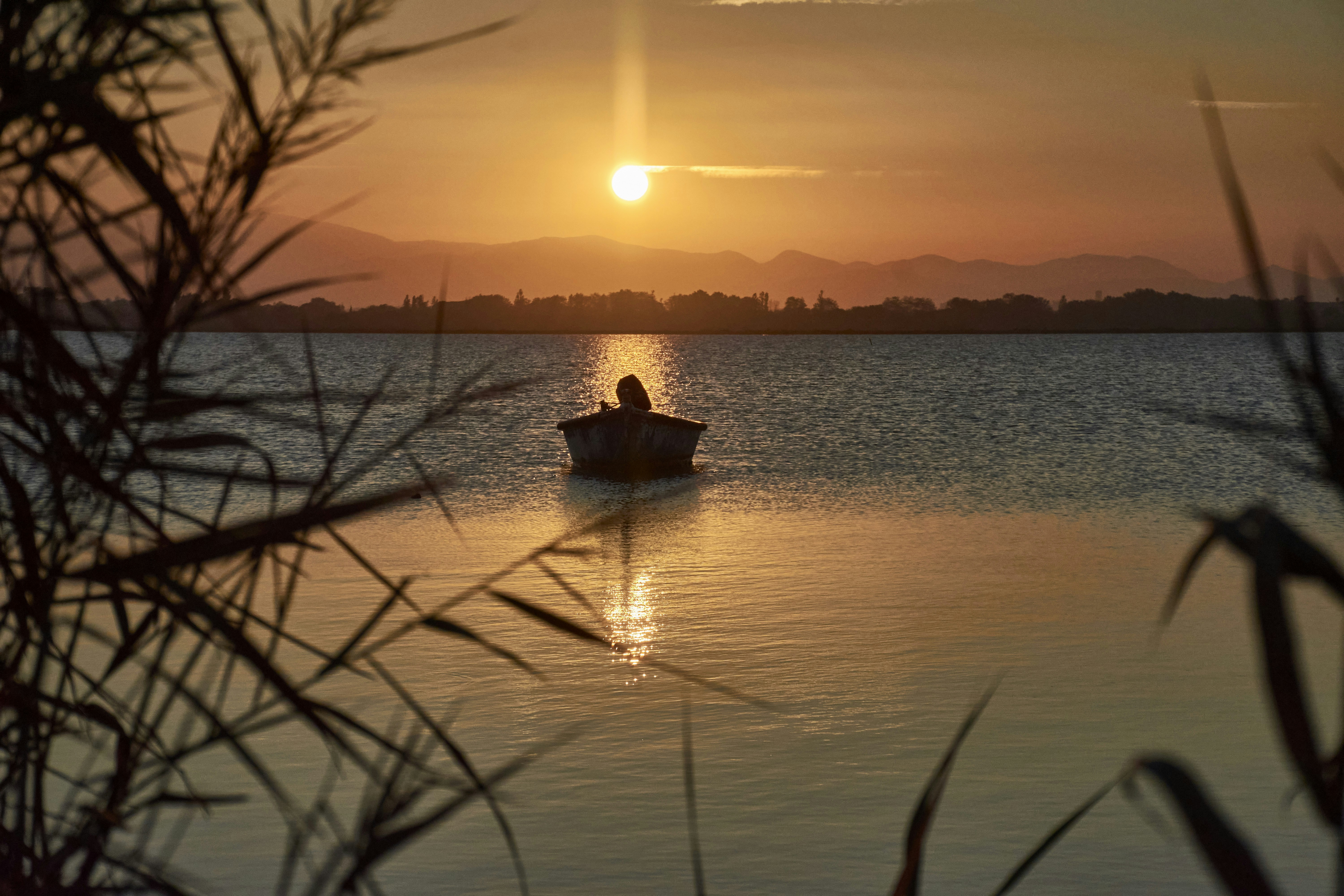a person in a small boat on a body of water