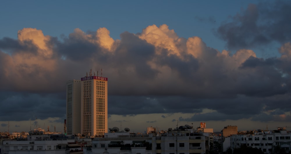 a tall building sitting under a cloudy sky