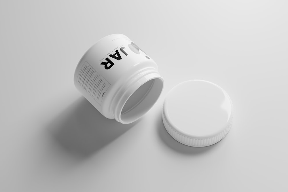 a bottle of pills on a white surface