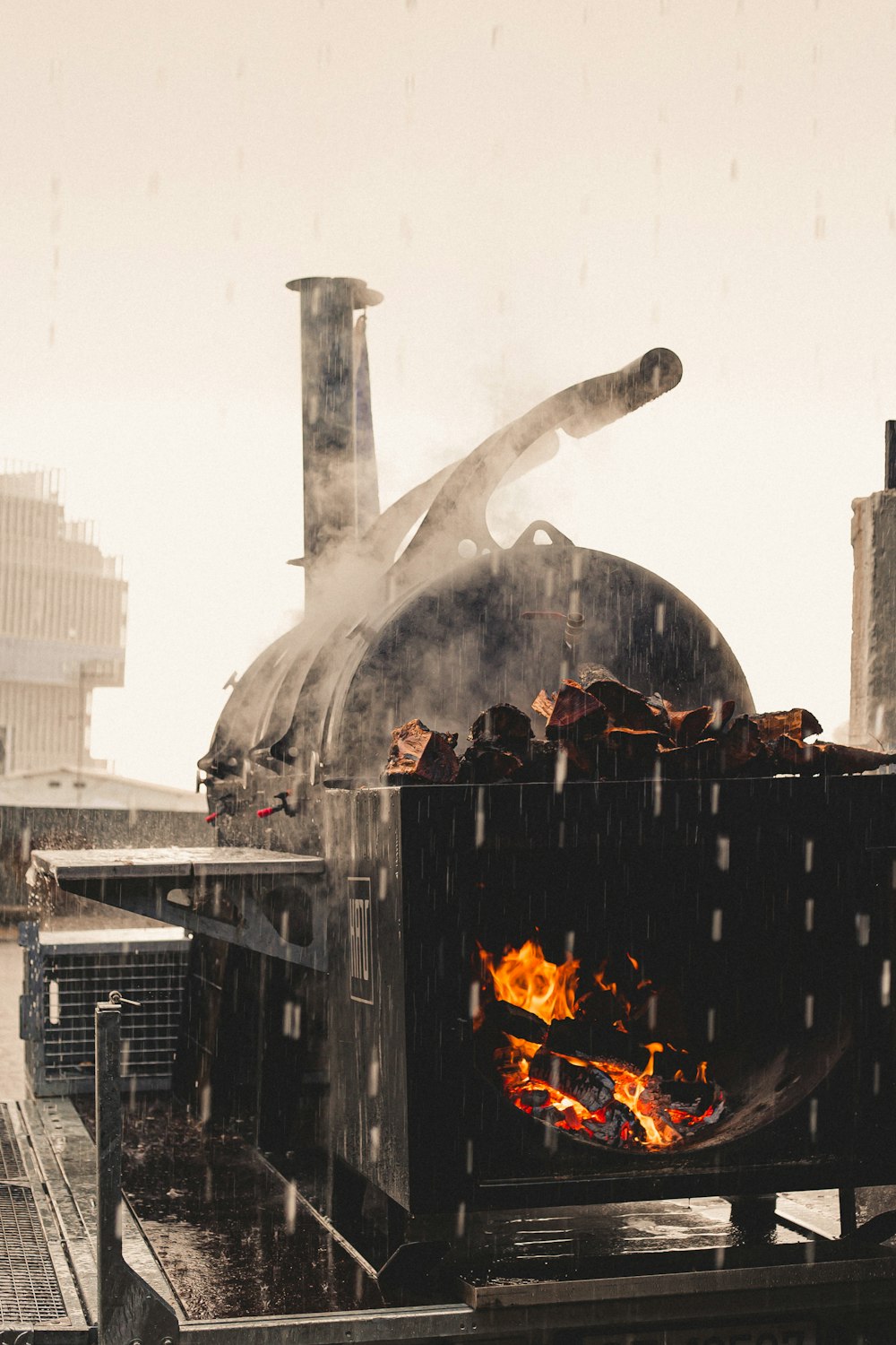 a man standing next to a large oven on top of a roof