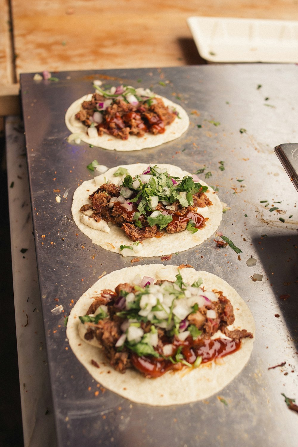 four tortillas sitting on top of a metal counter