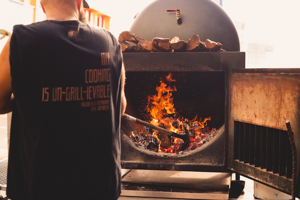 a man standing in front of a fire pit