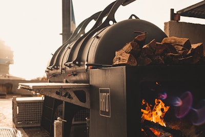 The Smoke Craft’s outdoor smoker glowing warmly in the evening light.