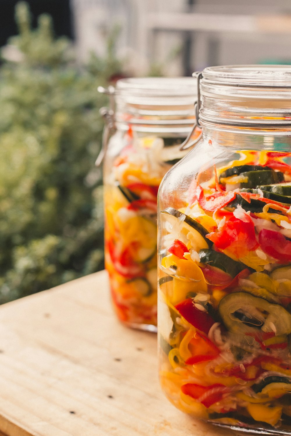 a couple of jars filled with different types of vegetables