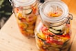 An assortment of traditional pickles and achar in colorful jars.