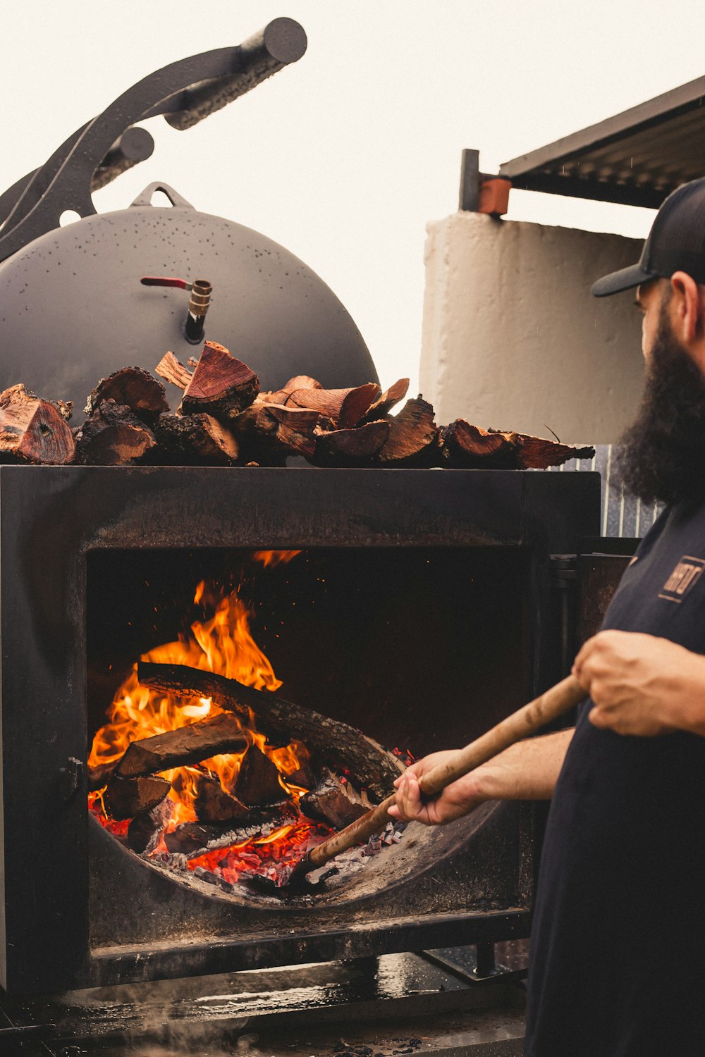 a man standing in front of an open grill