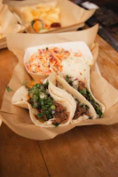A rustic taco truck serving carnitas tacos with steam rising from the freshly cooked pork.