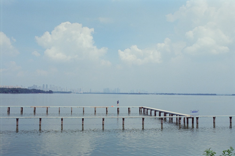 a large body of water with a long pier in the middle of it