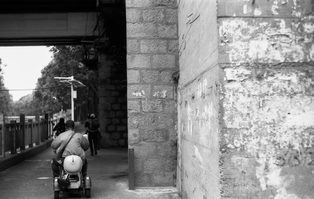 a woman pushing a stroller down a street