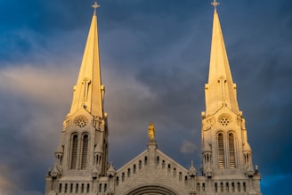a large cathedral with two spires against a cloudy sky