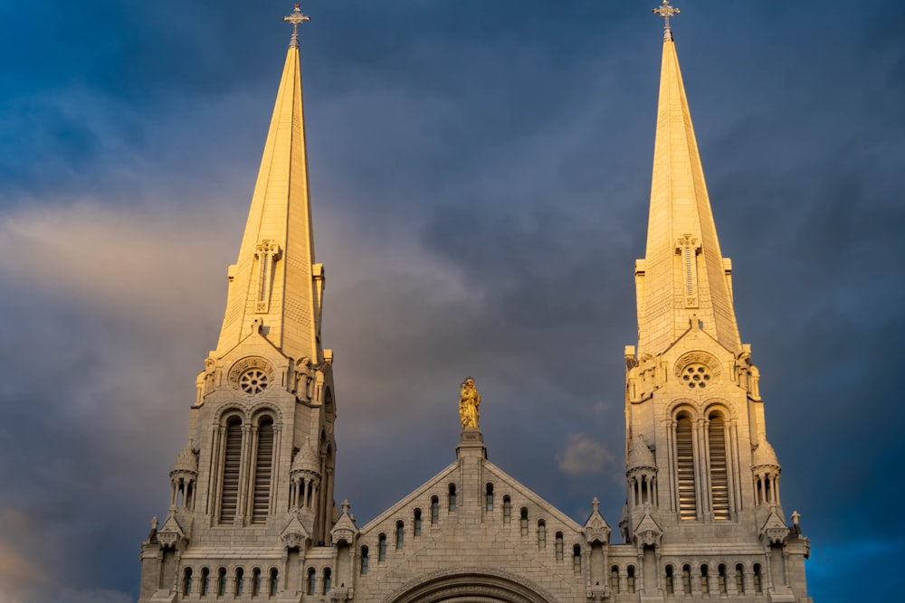 a large cathedral with two spires against a cloudy sky