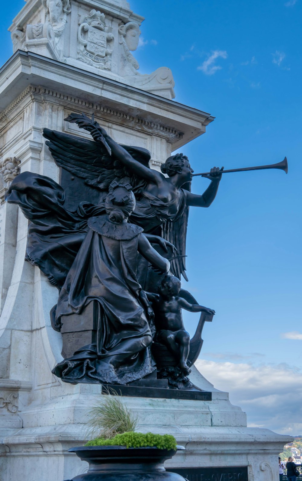 a statue of an angel holding a staff