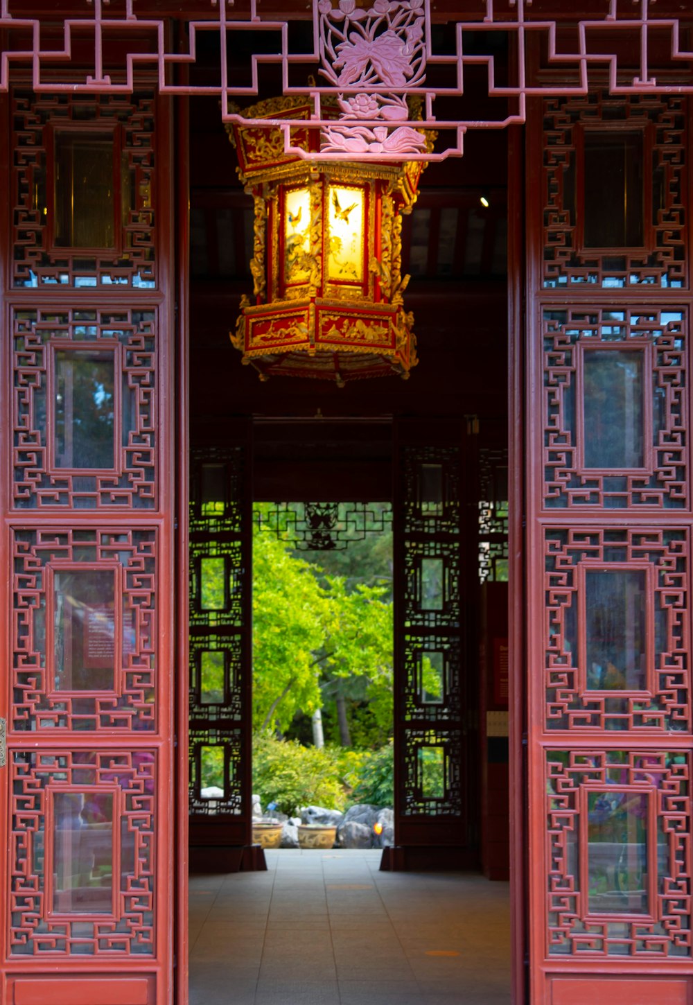 a red building with a light hanging from it's side