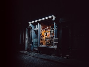 An inviting shopfront at dusk with illuminated property images catching the eye of passersby.