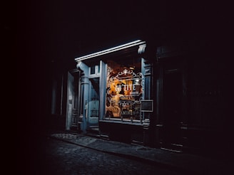 A custom-made wooden and metal storefront sign glowing warmly at dusk in Puebla.