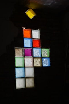 a stained glass window in a dark room