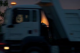 Image of a moving truck navigating through a sunny Dubai neighborhood.