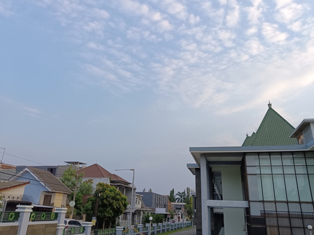 a view of a street with houses in the background