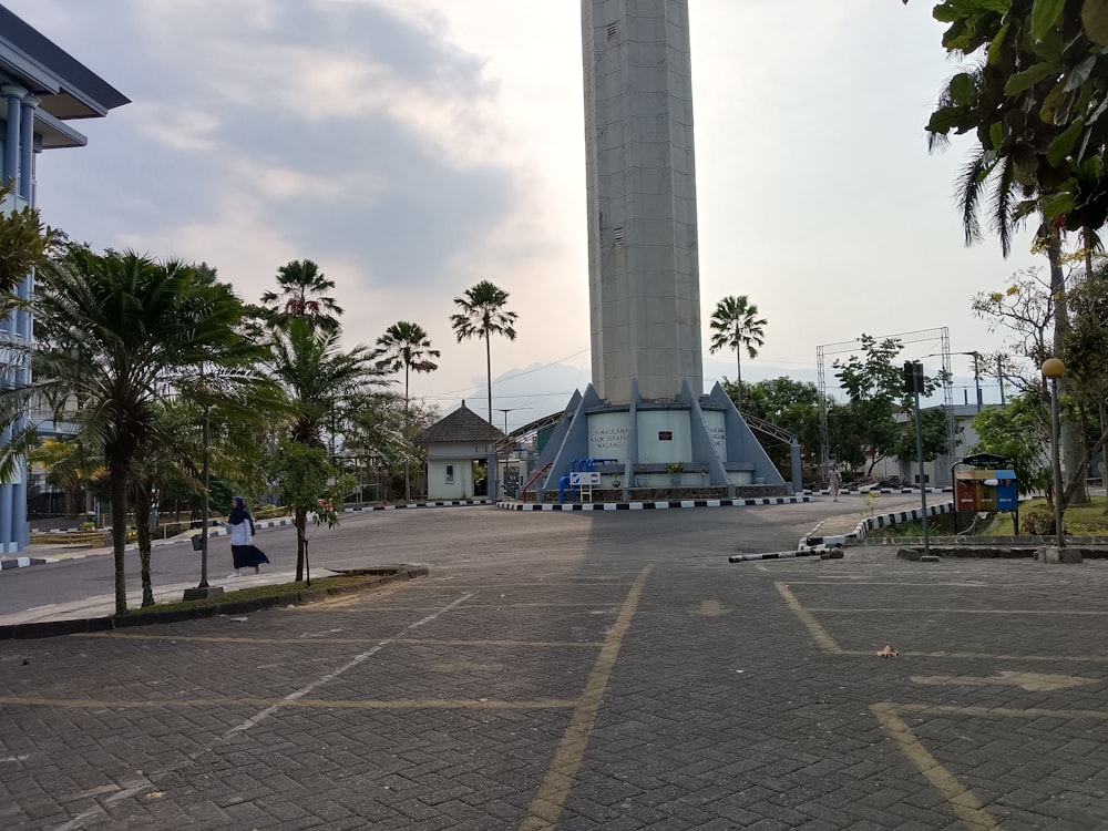 a clock tower in the middle of a parking lot