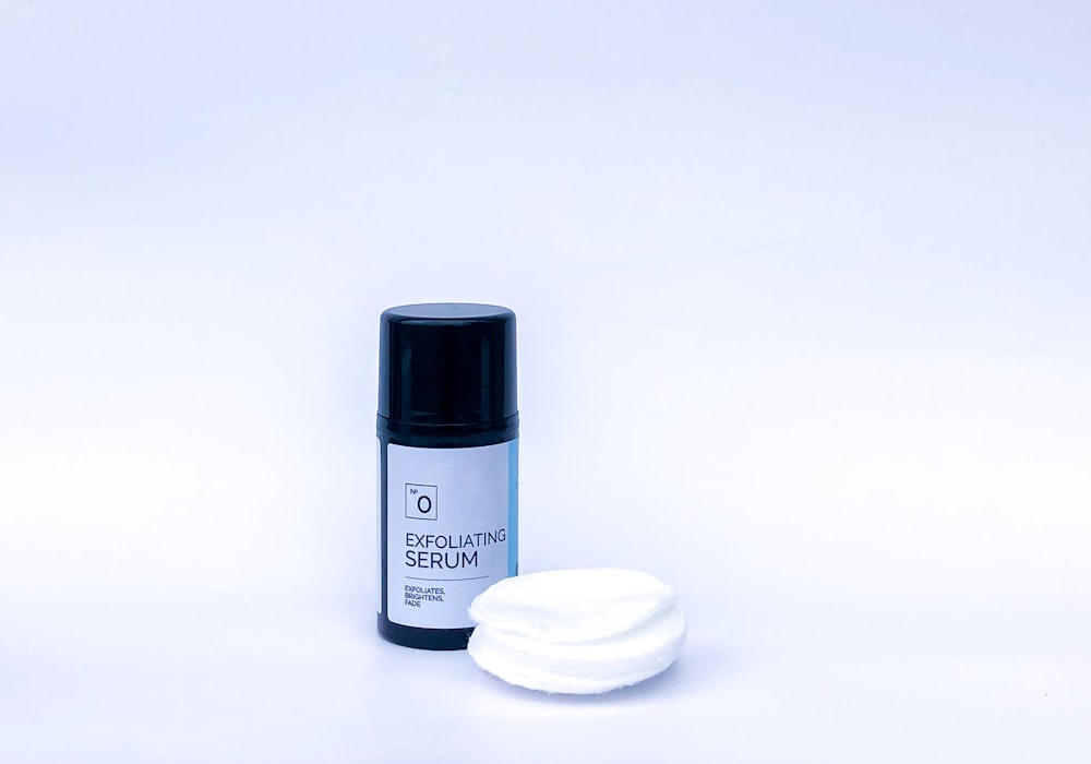 a bottle of deodorant sitting next to a white object