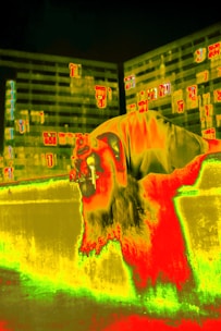 Thermal imaging camera capturing heat patterns on a residential building exterior.