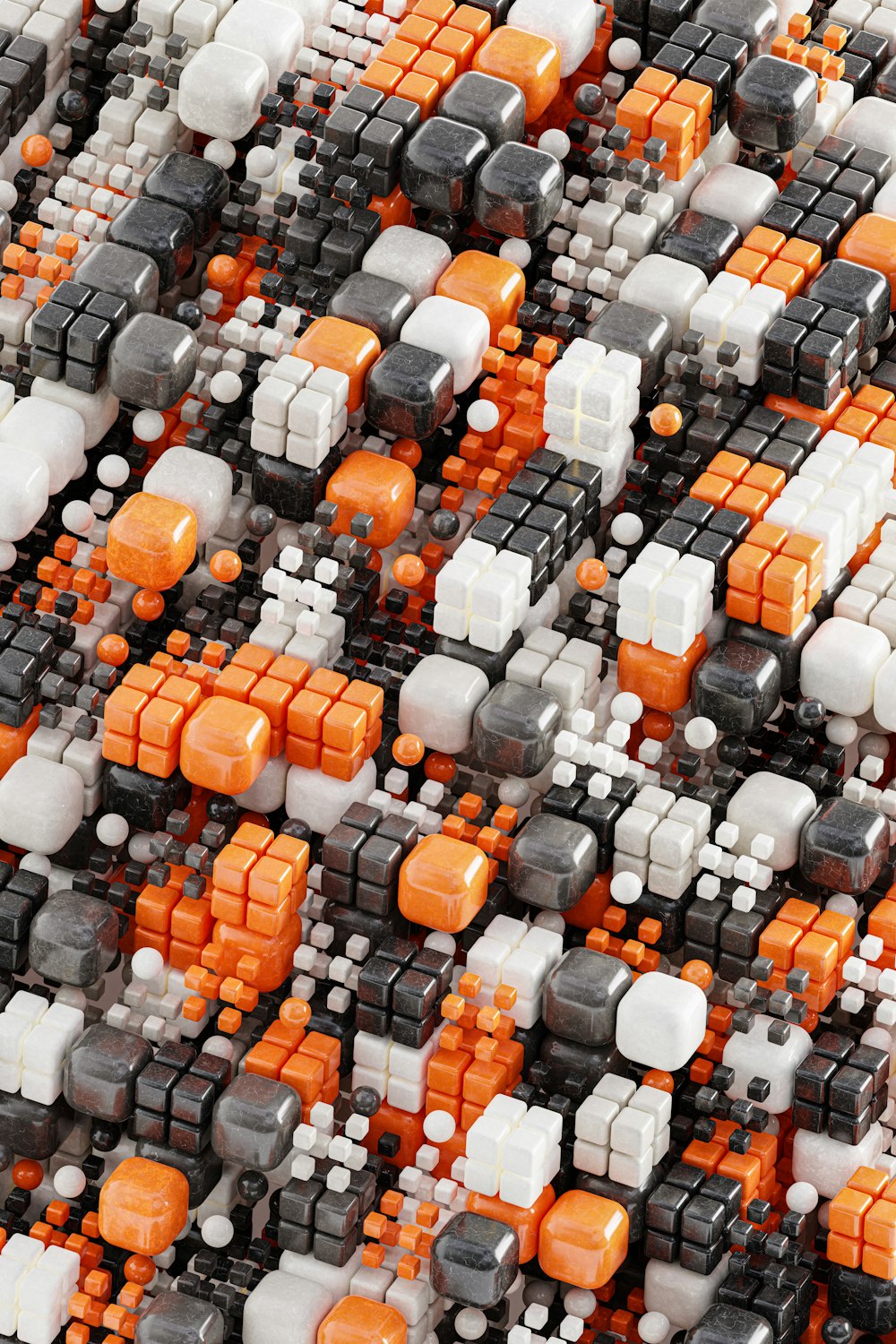 a close up of a pattern of orange, white, and black cubes