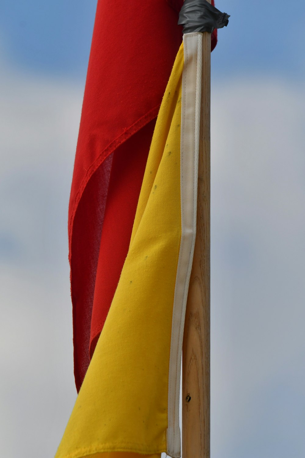 a close up of a red and yellow flag