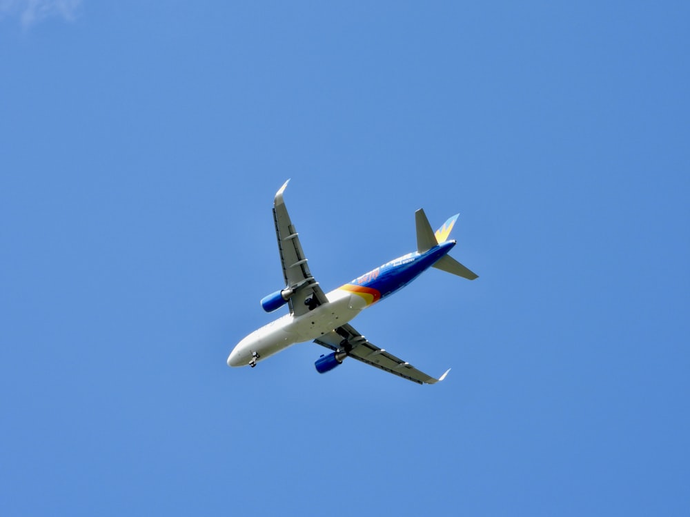 a large jetliner flying through a blue sky