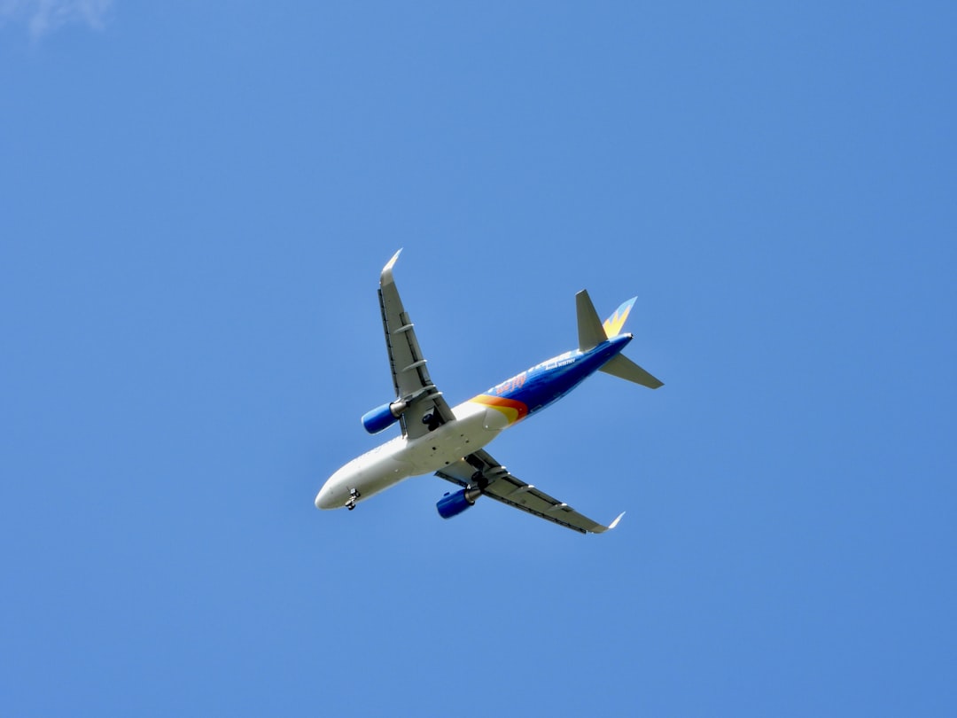 a large jetliner flying through a blue sky, A Southwest plane flying to the airport. Let