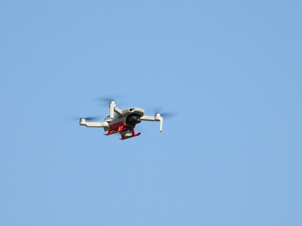 a small plane flying through a blue sky