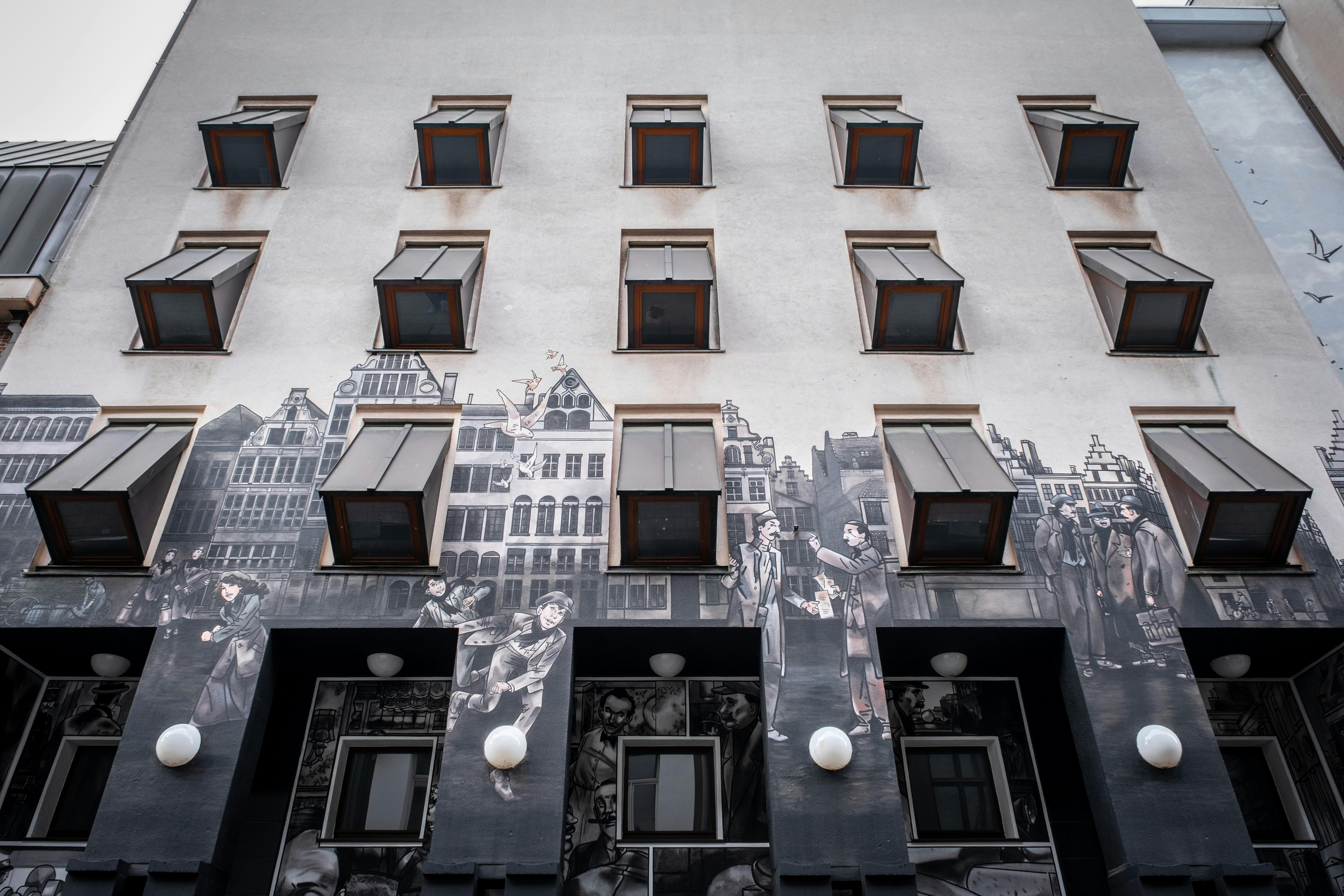 a building with many windows and a mural on the side of it