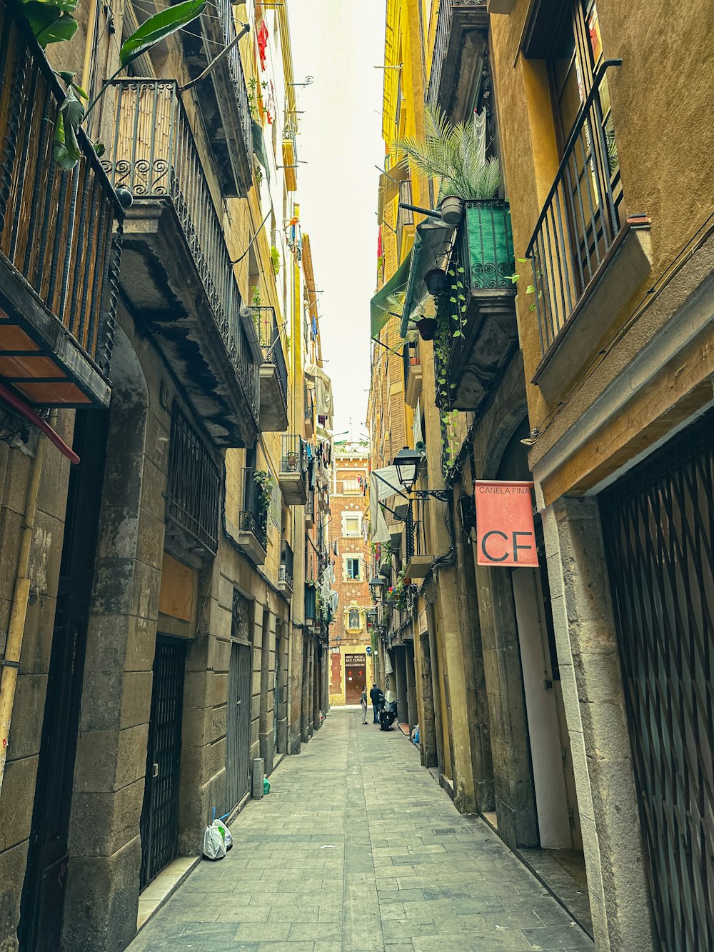 a narrow city street with buildings on both sides