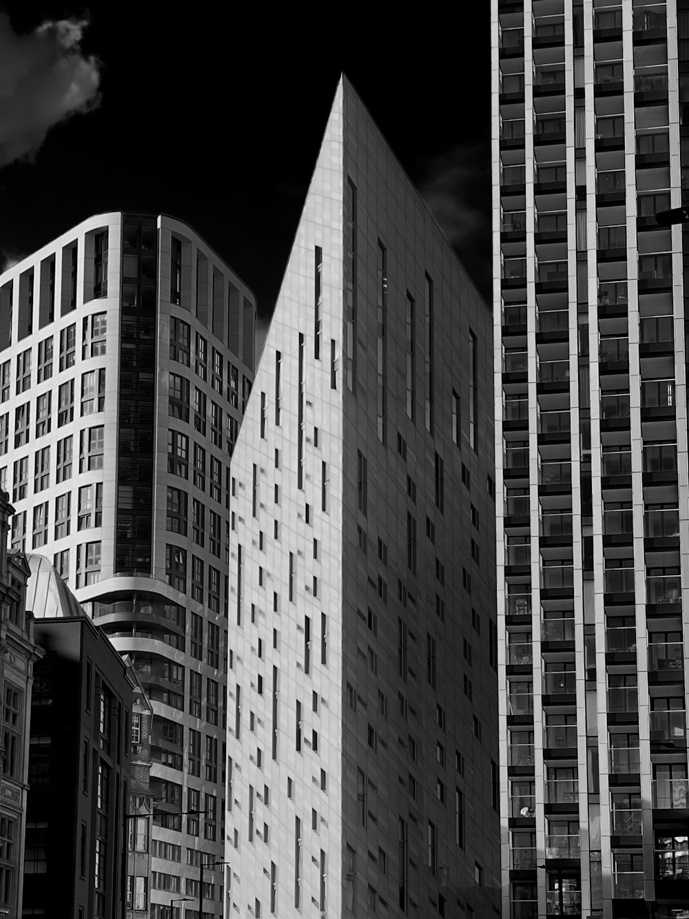 a black and white photo of tall buildings