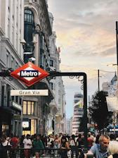 A vibrant photo of Madrid cityscape with travelers enjoying the sunny streets.