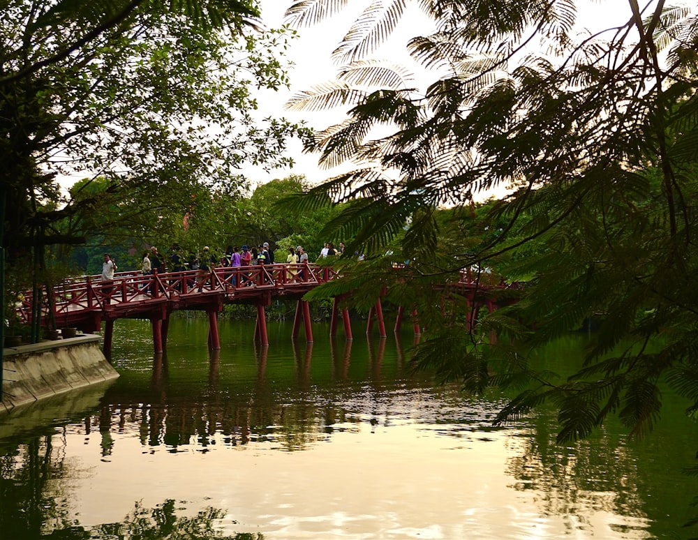 a red bridge over a body of water