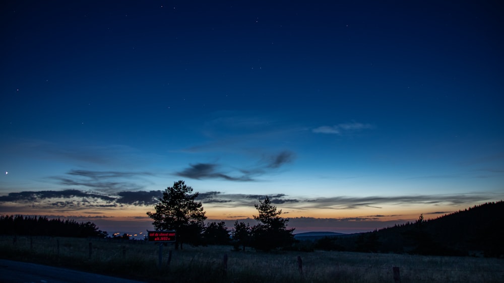 a night sky with a few clouds and a few stars