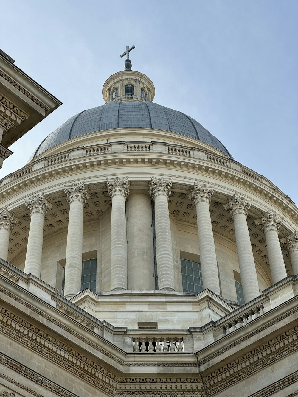 a large building with columns and a cross on top