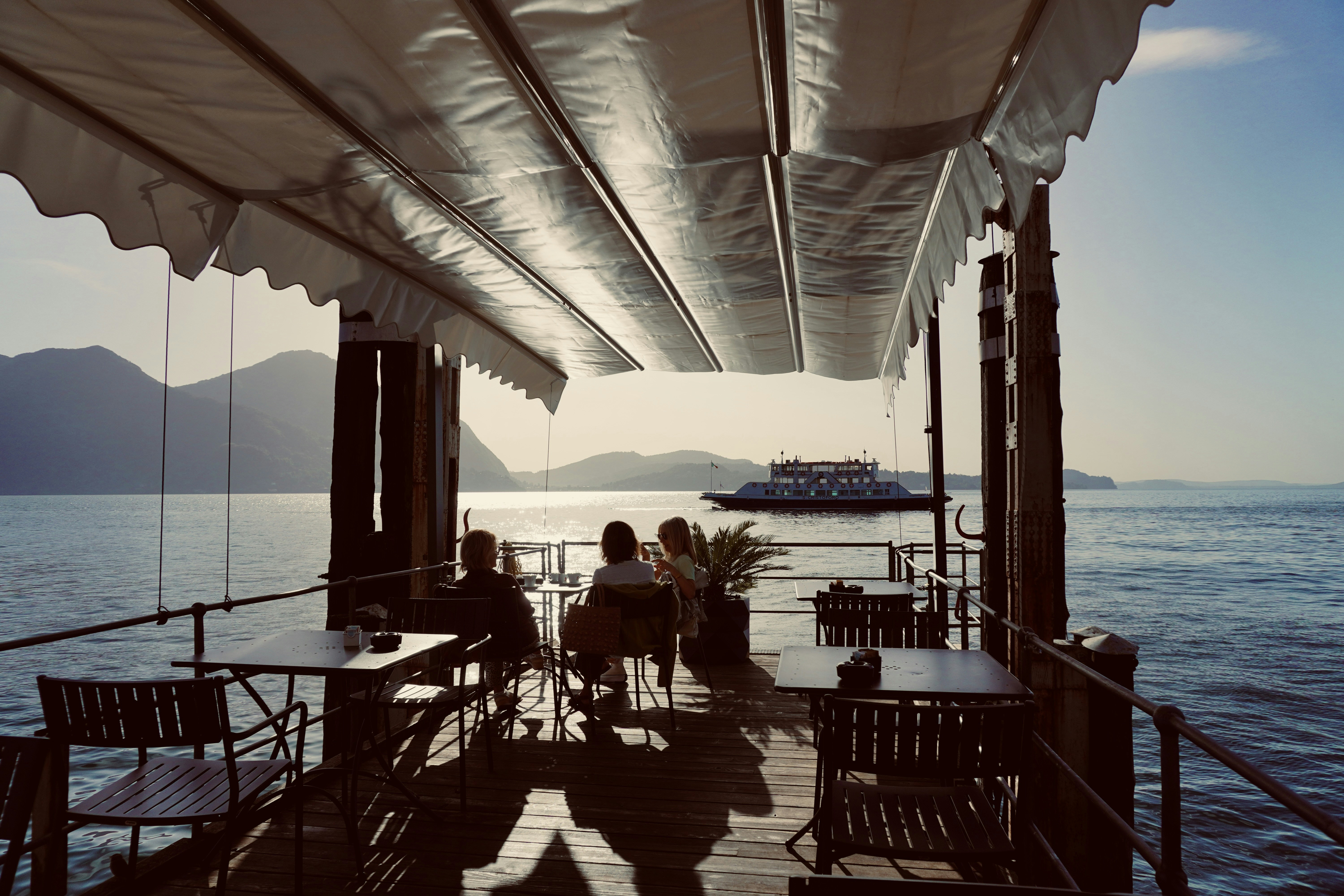 Brunch at the Lago Maggiore (Lake Maggiore) with ferry Intra - Laveno in the background photo by rouichi / switzerland