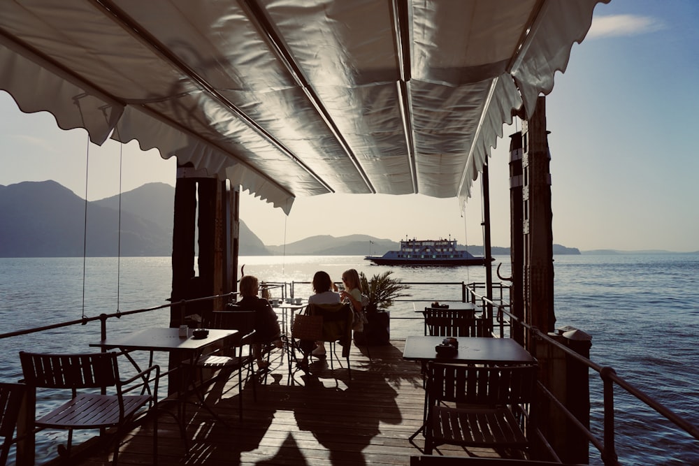 a group of people sitting at a table on a boat