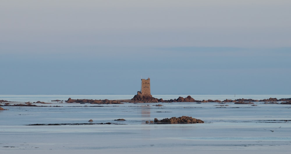 a large tower sitting on top of a beach next to the ocean