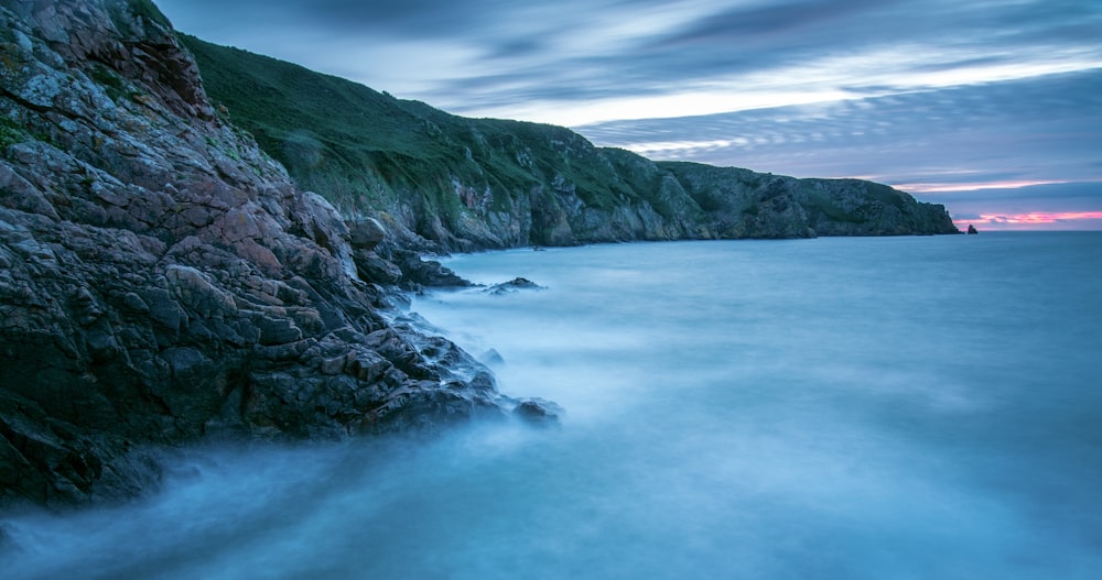 a long exposure photo of a rocky coastline