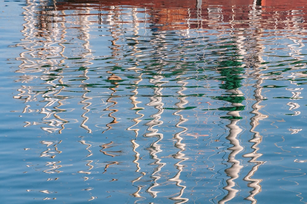 the reflection of a boat in the water